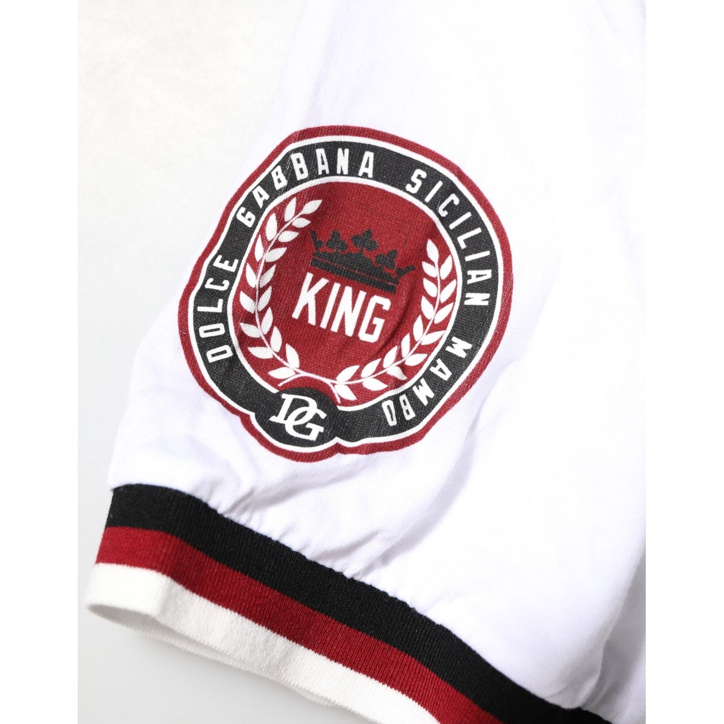 Close-up of Dolce & Gabbana White #DGMillennials King Crown V-neck T-shirt embroidered logo sleeve detail.