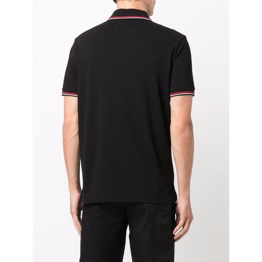 Back view of model wearing black Emporio Armani T-shirts and Polos with red and white accents, showcasing short sleeves and classic fit.
