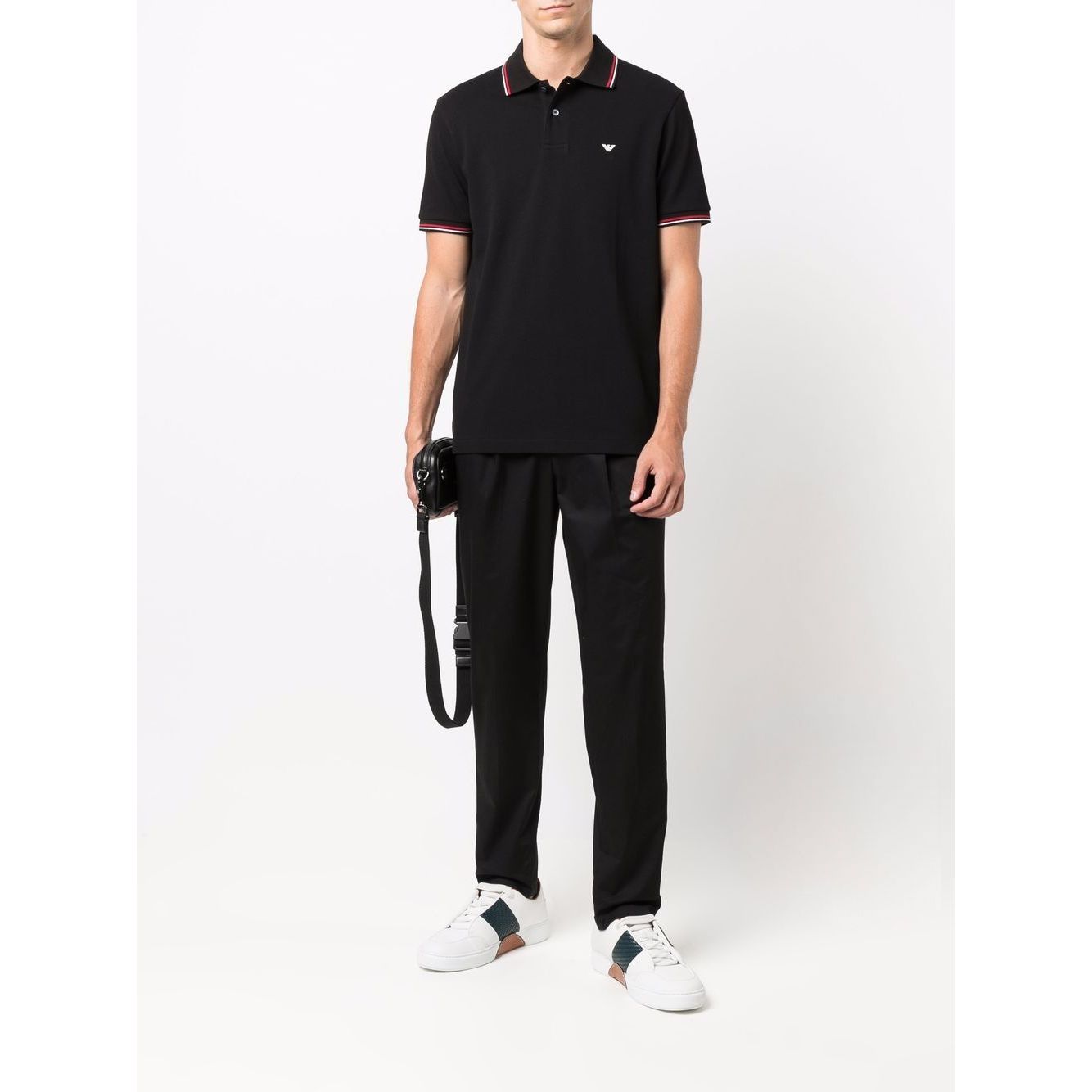 Model wearing Emporio Armani T-shirts and Polos Black with logo print, classic collar, short sleeves, and front button placket.