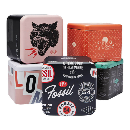 Assorted colorful Fossil vintage watch tins stacked in a creative arrangement showcasing retro designs and branding.