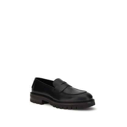 Ferragamo Black Rubber Slip-On Loafers with brushed calfskin upper and lug tread sole, offering a modern elegance and rugged allure.