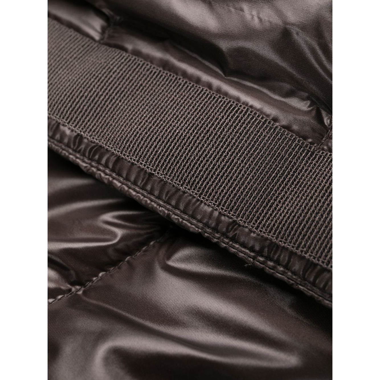 Close-up of padded design on Herno Jackets Brown with high neck and hidden front closure, featuring nylon texture in brown color.