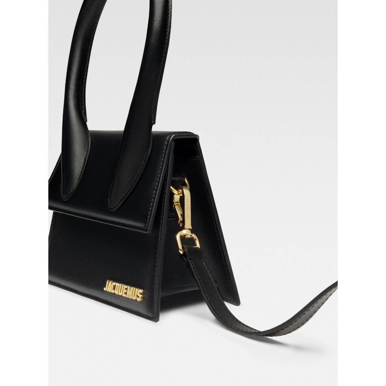 Jacquemus Le Chiquito Moyen Black Bag with gold hardware, removable strap, and reinforced handle showcasing luxury Italian design.