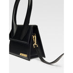 Jacquemus Le Chiquito Moyen Black Bag with gold hardware, featuring a reinforced handle and removable long shoulder strap.