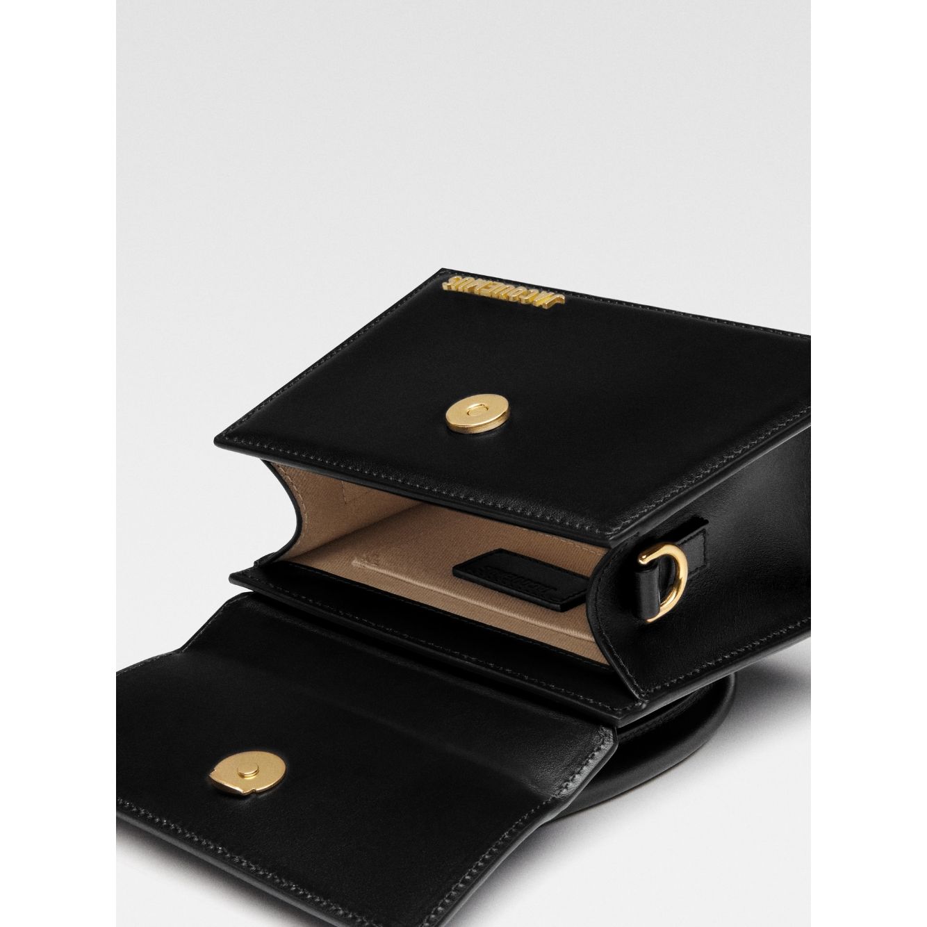 Jacquemus Le Chiquito Moyen Black Bag with gold hardware, open view showing inside pocket and magnetic flap closure, made in Italy.