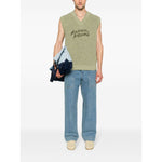 Model wearing Maison Kitsuné MAISON KITSUNE' Jeans Clear Blue with wide leg and light blue denim, paired with a sleeveless top.