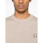 Model wearing Maison Kitsuné Maison Kitsune Fox motif sweater in light beige with crew neck and fox head logo, size M.