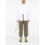 Maison Kitsuné Maison Kitsune classic shirt wth fox head logo, white cotton with button fastening, worn by model holding a bag.