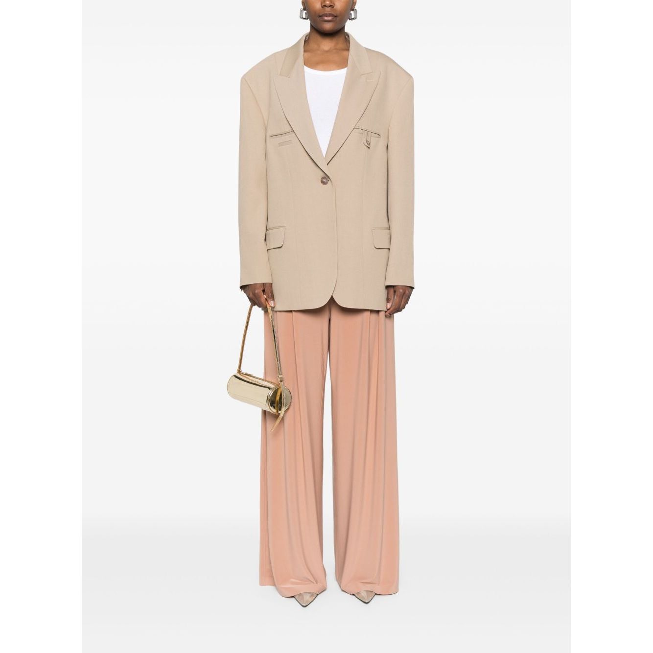 Model wearing Norma Kamali Trousers Beige with elasticated waistband, wide leg, and high-waist design, paired with beige blazer and small purse.