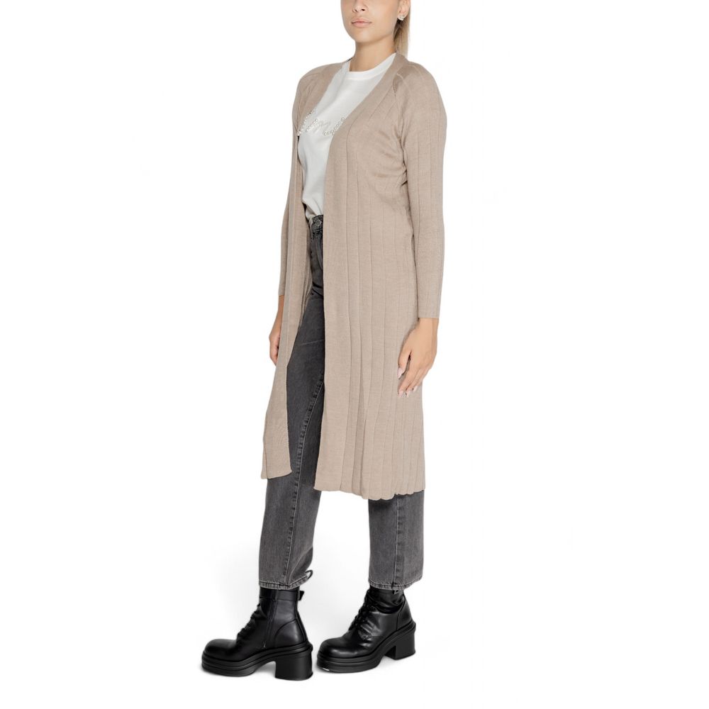 Model wearing Only Beige Marabou Cardigan with jeans and boots, showcasing the long open design perfect for layering.