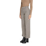 Woman wearing Only Beige Polyester Pant, fall/winter collection, side view with black boots, focuses on polyester blend texture.