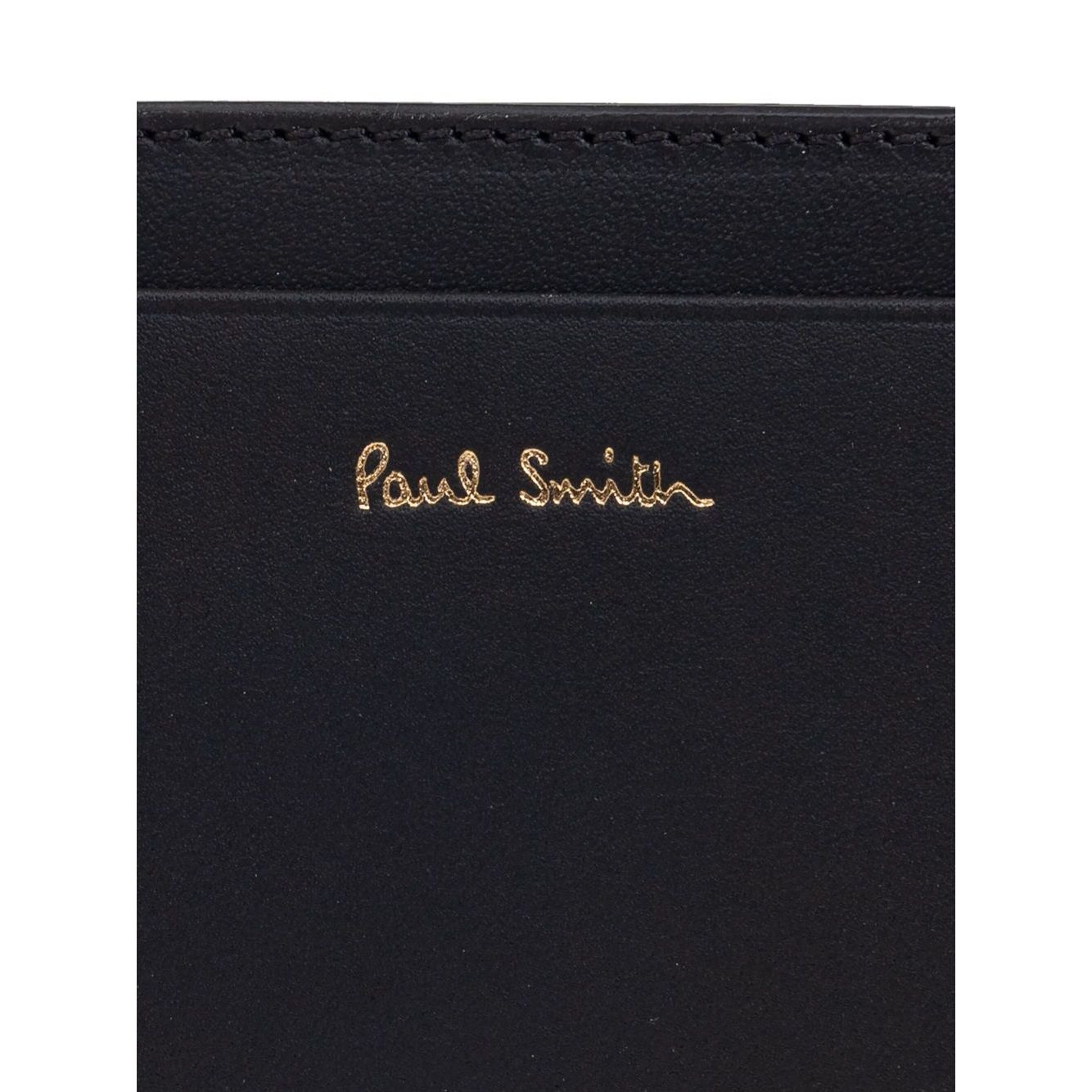 Paul Smith Signature Stripe leather card case with black card slots and logo stamp on the front.