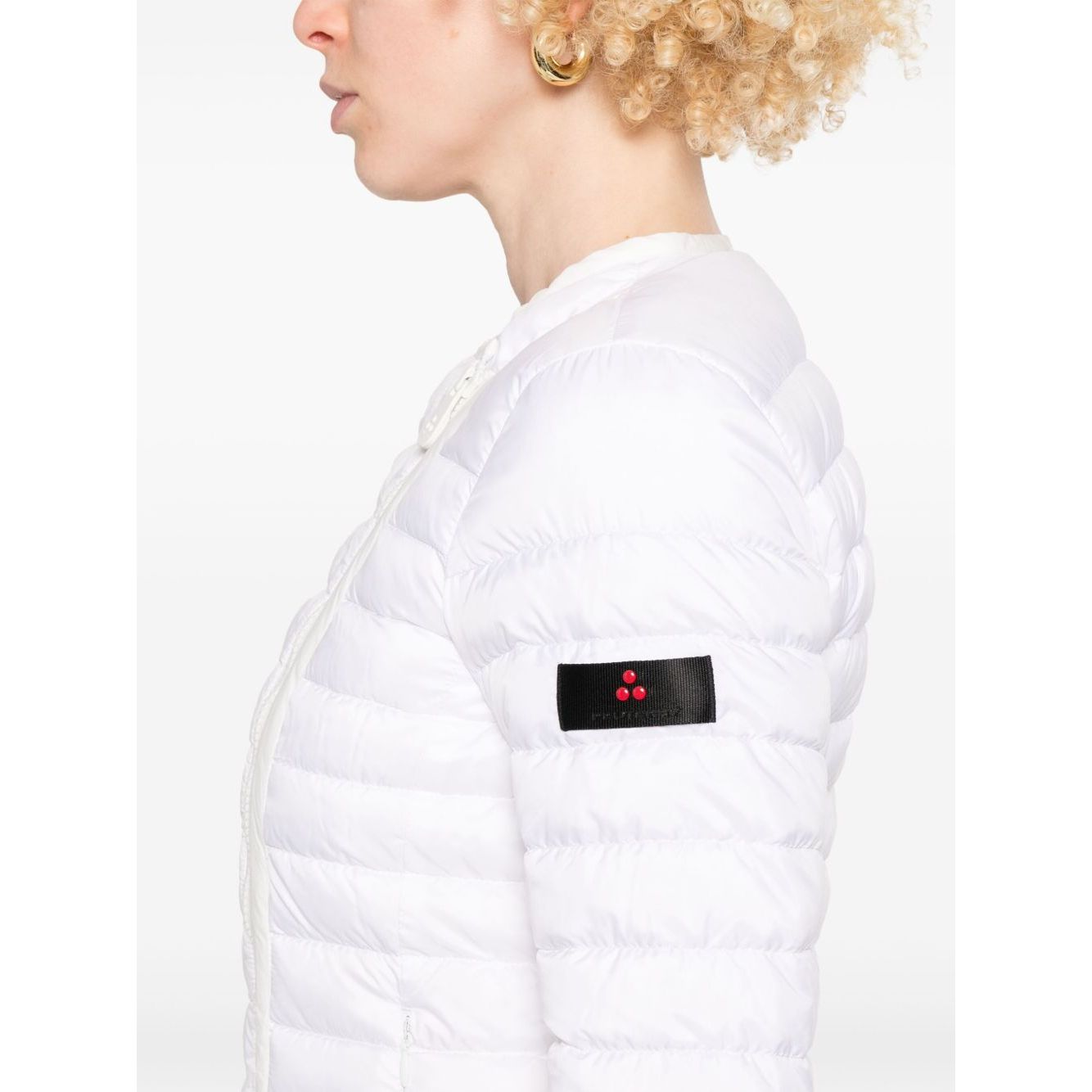 Side view of Peuterey Coats White with logo patch, featuring two-way zip and side pockets, worn by model in down-filled crew neck style.
