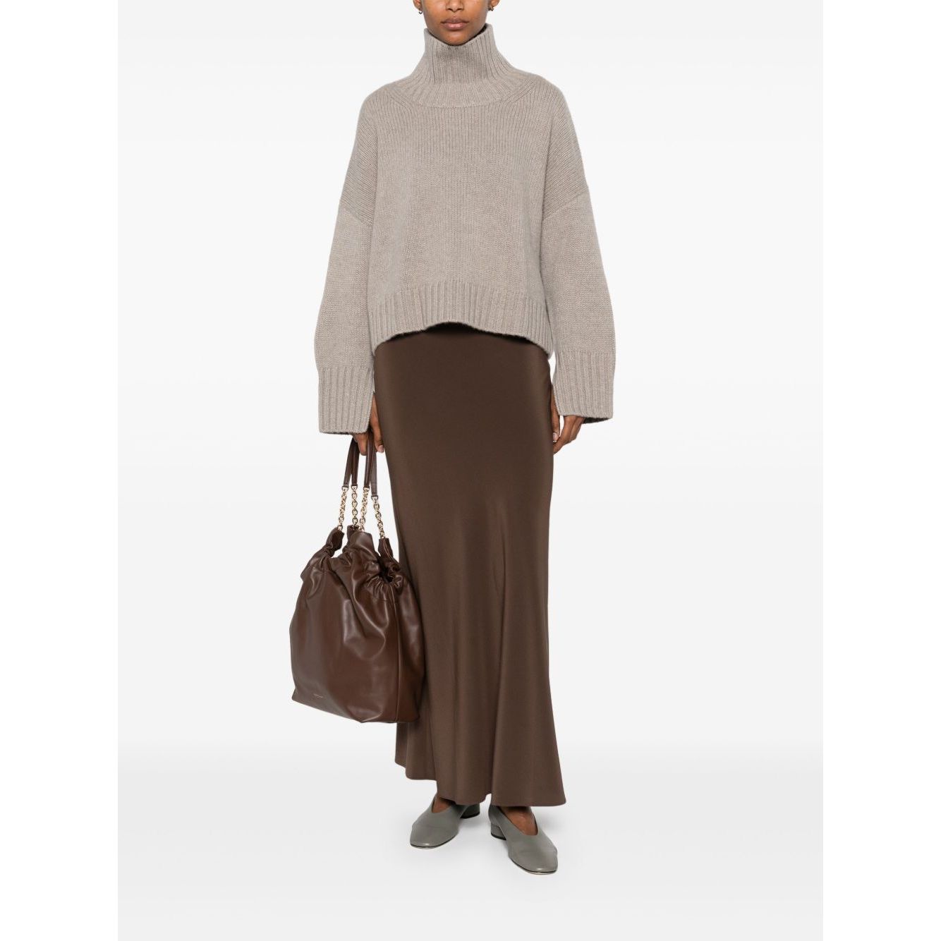 Model wearing SOFT GOAT Sweaters Light Grey cashmere turtleneck jumper with taupe ribbed trim and long sleeves, styled casually.