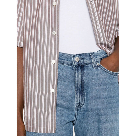 Person wearing Seven Jeans Blue with light blue concealed fly, button fastening, and striped shirt showcasing wide-leg denim style.