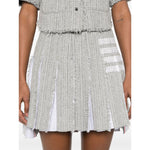 Medium grey cotton blend skirt featuring side button and zip fastening, frayed edges, and signature 4-Bar stripe by Thom Browne Skirts Grey.