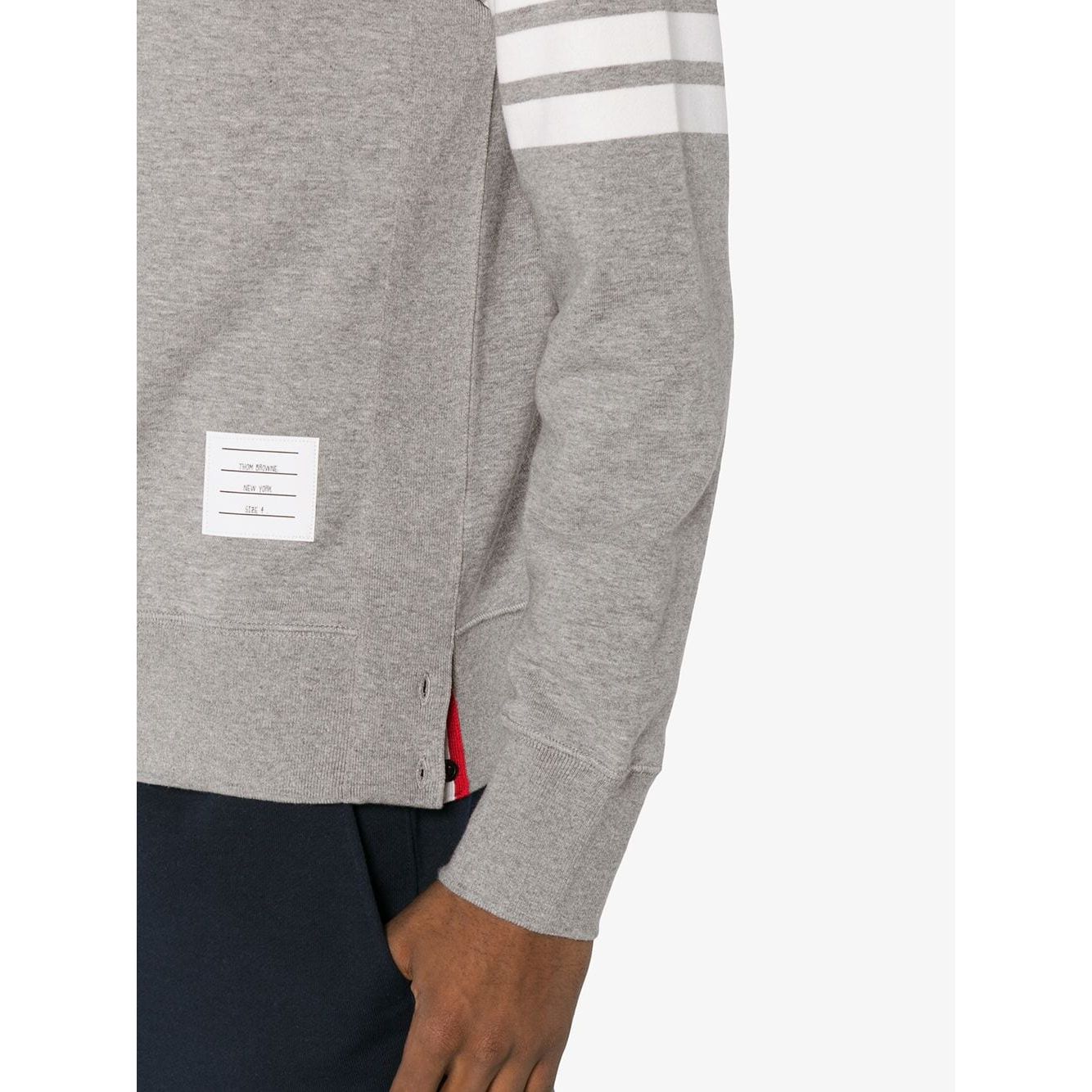 Side view of Thom Browne Sweaters Light Grey with 4-Bar stripe and name tag on the left arm.