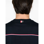 Thom Browne T-shirts and Polos Blue featuring midnight blue with signature grosgrain side tabs and RWB stripe detailing, back view.