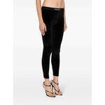 Model wearing Tom Ford Trousers Black velvet leggings with elasticated logo waistband, showcasing true-to-size fit and stretch-design.