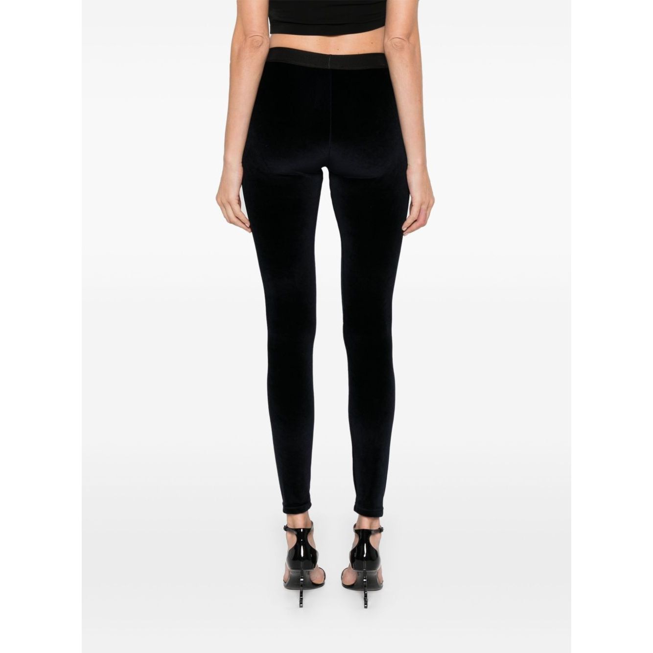 Rear view of model wearing Tom Ford Trousers Blue, high waist velvet leggings with elasticated logo waistband, skinny cut.