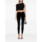 Model wearing Tom Ford Trousers Blue, midnight blue velour leggings with high waist and elasticated logo waistband.