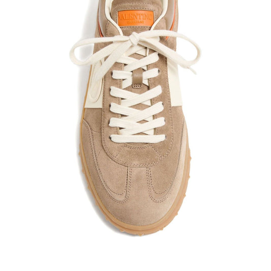 Valentino Garavani Upvillage Crust Leather Sneaker in caramel brown with panelled design and logo detail, top view.