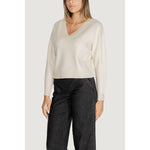Woman wearing Vero Moda White Viscose Sweater with V-neck and long sleeves, styled with black trousers for a chic look.